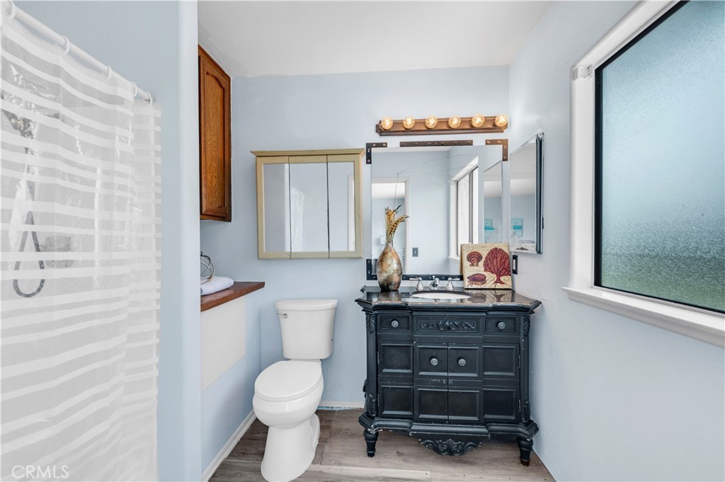 Bathroom with Decorative Mirror and Elevated Finishes
