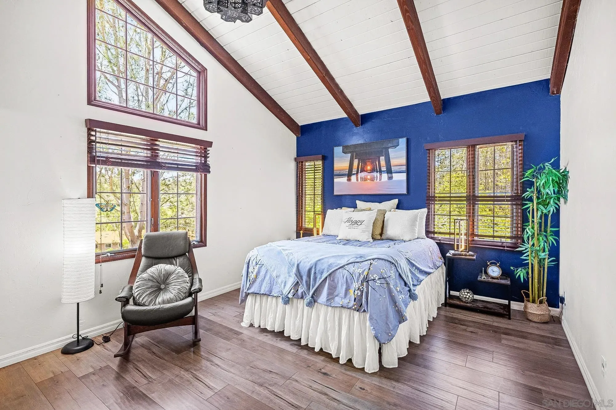 Vaulted Bedroom with Statement Wall and Large Windows