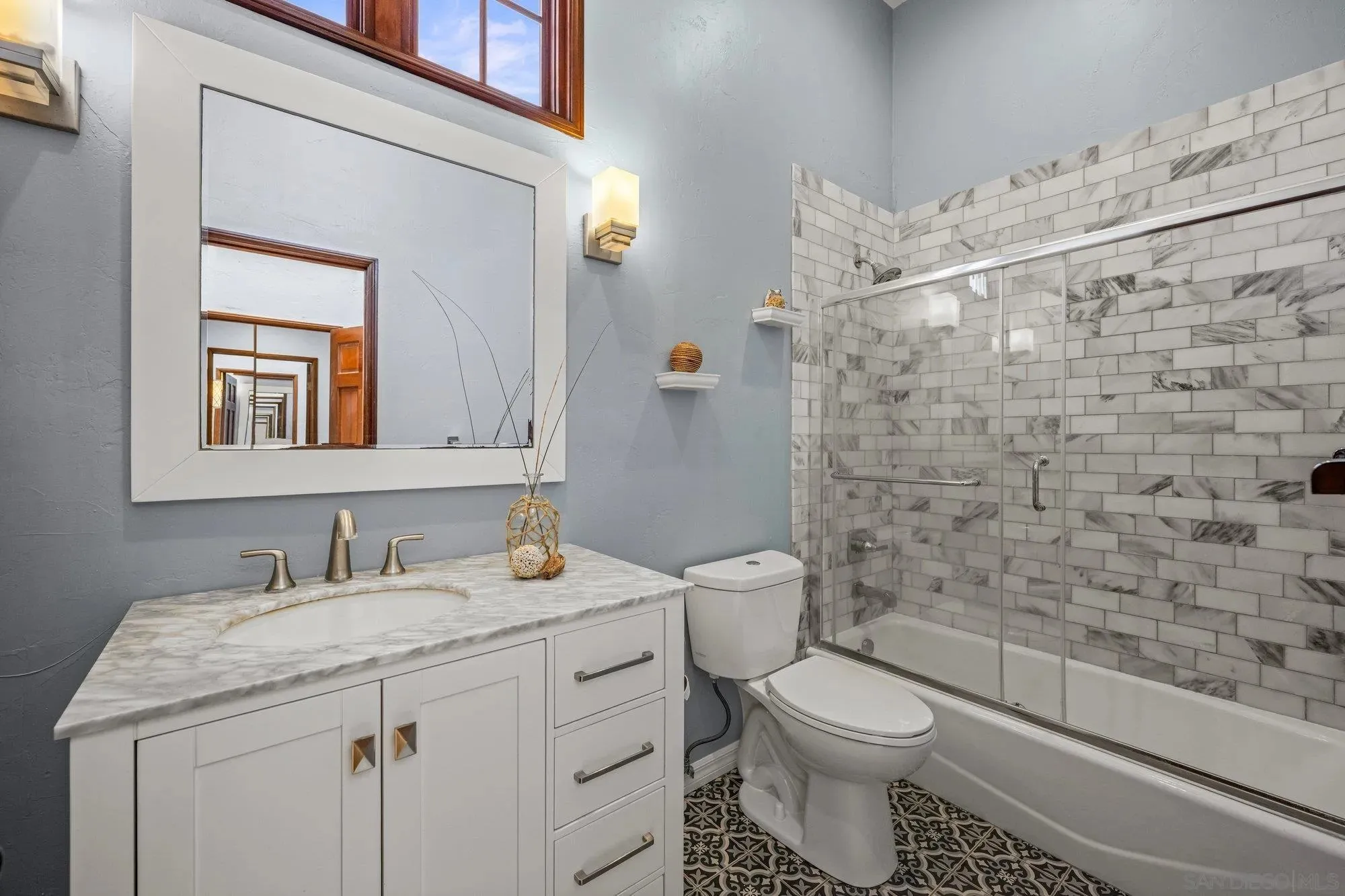 Spa-Inspired Bathroom with Marble Tile and Dual Vanity