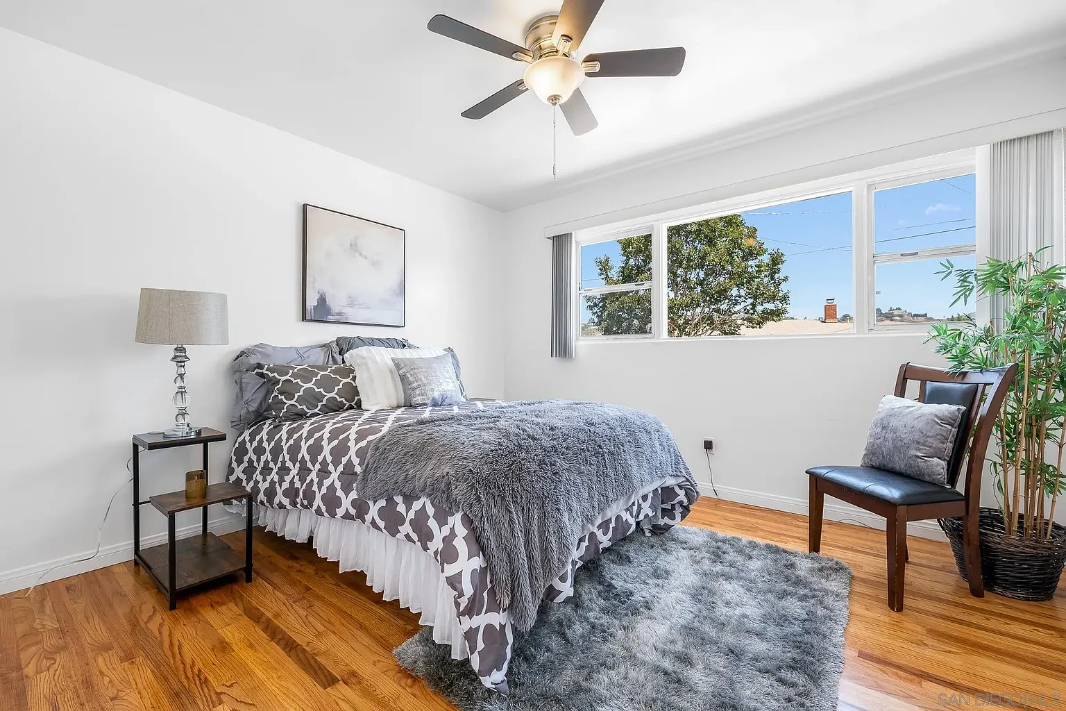 Primary Bedroom Staged with Soft Neutrals and Serene Views